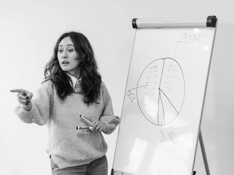Professional woman delivering a speech to a large audience.