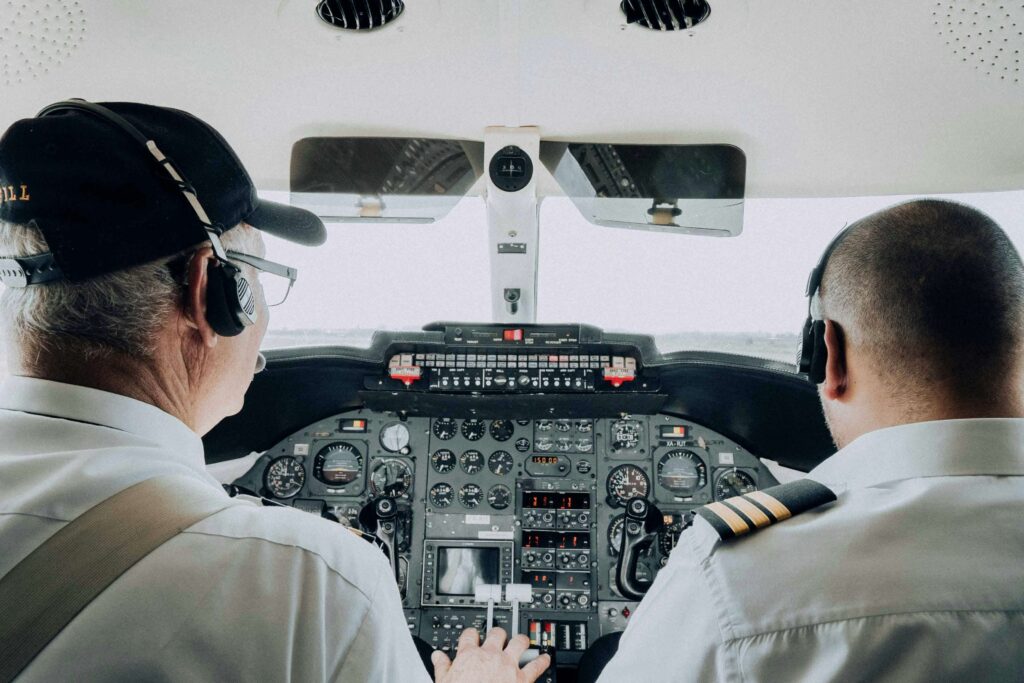 Pilot adjusting flight controls mid-air symbolizing real-time communication adjustments